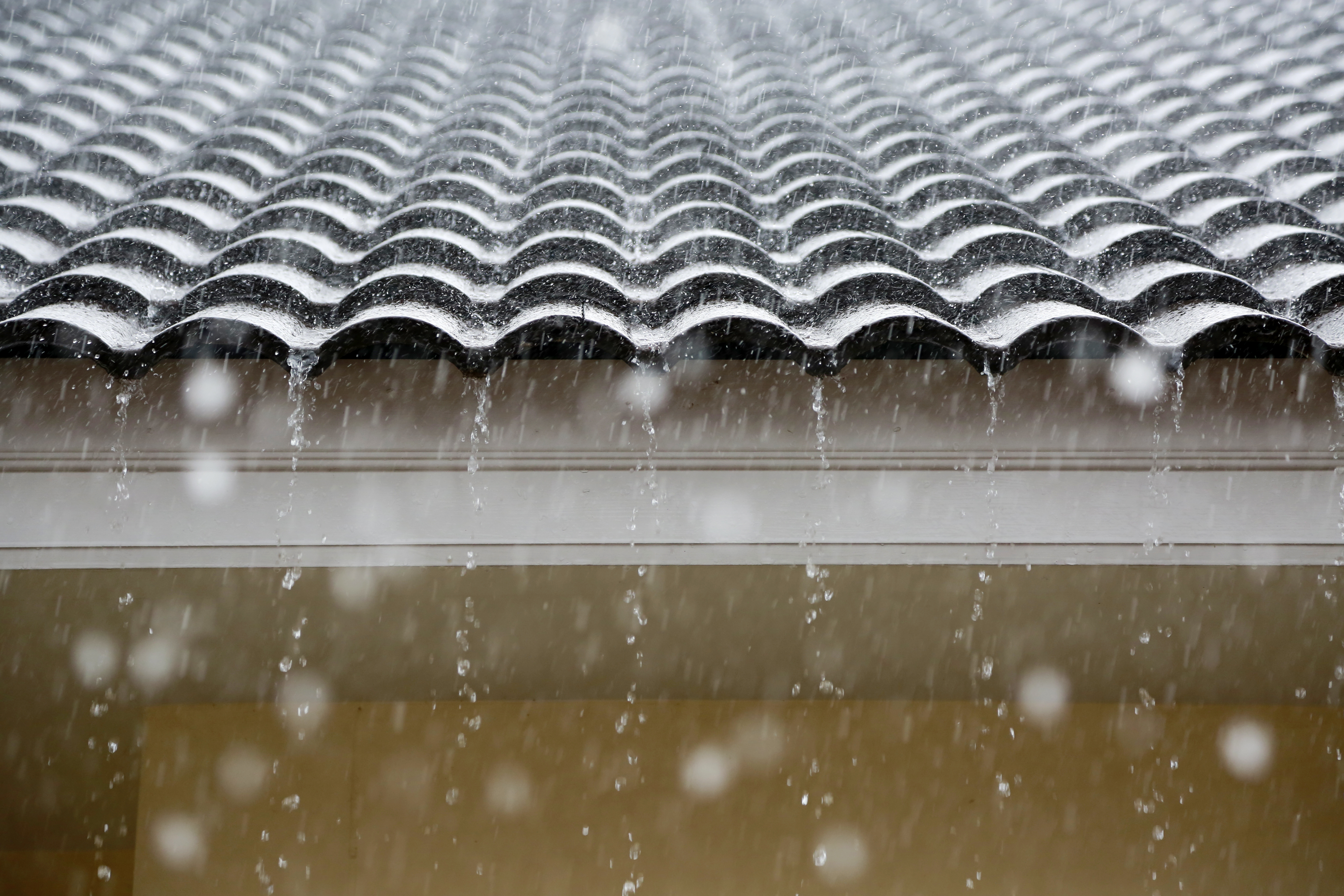 Rain pouring off a roof during a storm